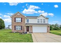 Two-story brick home with a two-car garage and landscaped yard at 1560 Cold Spring Dr, Brownsburg, IN 46112