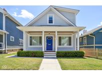 Charming gray house with a blue door, white columns, and well-manicured lawn at 805 Iowa St, Indianapolis, IN 46203