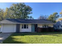 White ranch home with attached garage and teal door at 3720 Breen Dr, Indianapolis, IN 46235