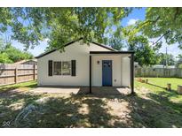 Charming white house with a blue door and covered porch at 929 Olin Ave, Indianapolis, IN 46222