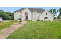 Two-story white brick house with a fountain and landscaped yard at 8292 S State Road 39 S Rd, Clayton, IN 46118