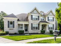 Brick two-story house with a landscaped lawn at 8235 Ridge Valley Ct, Indianapolis, IN 46278