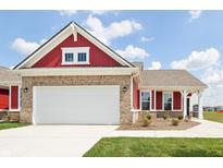 Red and brown two-story home with a white garage door at 225 Marble Wood Dr, Danville, IN 46122