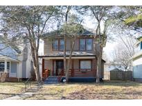 Two-story house with a porch and landscaping at 526 N Emerson Ave, Indianapolis, IN 46219