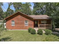 Rustic wooden house with a small porch and yard at 8157 Center Lake Rd, Nineveh, IN 46164