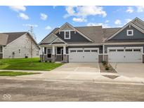 Craftsman style home with gray siding, stone accents, and a two-car garage at 16910 Cattle Hollow Ln, Noblesville, IN 46060