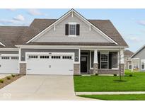 Gray Craftsman style home with a two-car garage and landscaped lawn at 16848 Cattle Hollow Ln, Noblesville, IN 46060