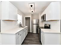 Modern kitchen with white cabinets and quartz countertops at 1622 N Linwood Ave, Indianapolis, IN 46218