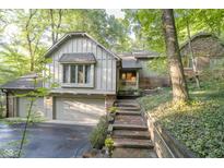Two-story home with brick and siding exterior, and a two car garage at 6235 Johnson Rd, Indianapolis, IN 46220