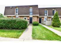 Brick townhouse with a neat lawn and shrubs at 7338 Country Brook Dr, Indianapolis, IN 46260