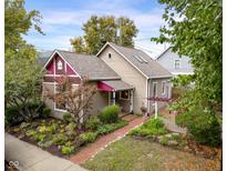 Charming house with a well-manicured front yard and brick pathway at 646 E 9Th St, Indianapolis, IN 46202
