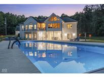 Luxury home with a sparkling pool and expansive patio; perfect for outdoor entertaining at 5181 S Poplar Dr, Columbus, IN 47201