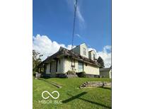 Two-story house, light beige siding, gabled roof and small yard at 3302 Columbus Ave, Anderson, IN 46013