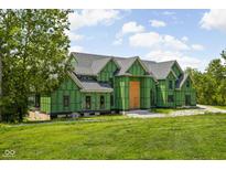 New house under construction with gray roof and green house wrap at 1122 Laurelwood, Carmel, IN 46032