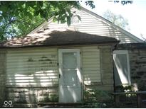 Older home with white siding and stone foundation at 3242 S Rybolt Ave, Indianapolis, IN 46221