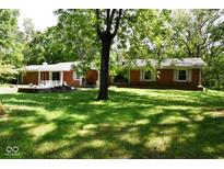 Brick ranch house with large backyard and mature trees at 9100 S Us Highway 35, Muncie, IN 47302