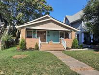 Brick home with front porch and landscaping at 1344 Barth Ave, Indianapolis, IN 46203