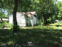 Small house exterior with overgrown yard at 3336 S Rybolt Ave, Indianapolis, IN 46221