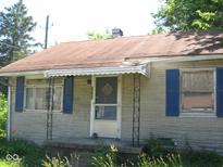 Tan brick ranch house with blue shutters and a small porch at 2901 S Taft Ave, Indianapolis, IN 46241