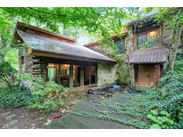 Log and stone home nestled in woods at 9307 E Dill Rd, Morgantown, IN 46160