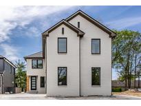 White brick two-story home with gray roof and modern black windows at 441 W 86Th St, Indianapolis, IN 46260