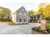 Brick house with a three-car garage and landscaping at 437 W 86Th St, Indianapolis, IN 46260