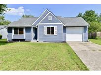 Exterior of a charming blue house with a neatly landscaped lawn and attached garage at 2813 Grassy Creek Dr, Indianapolis, IN 46229