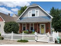 Charming 2-story home with gray siding and white picket fence at 32 E Caven St, Indianapolis, IN 46225