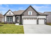 Two-story home with stone accents and a three-car garage at 15827 Scarteen Rd, Fishers, IN 46040