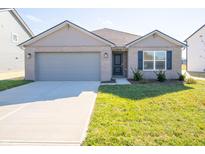 Brick ranch home with gray garage door and landscaped lawn at 6205 Card Blvd, Indianapolis, IN 46221