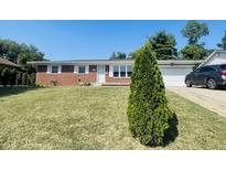 Brick ranch house with a well-maintained lawn at 2416 Radcliffe Ave, Indianapolis, IN 46227