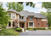 Brick house exterior with landscaping and circular driveway at 8011 Morningside Dr, Indianapolis, IN 46240