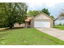 Brick ranch home with attached garage and spacious lawn at 6008 Mcclellan Ct, Indianapolis, IN 46254