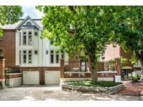 Brick townhouse with a two-car garage and landscaping at 571 Lockerbie S Cir, Indianapolis, IN 46202