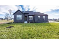 Brick house with a two-car garage and a well-manicured lawn at 6631 Dogwood Dr, McCordsville, IN 46055