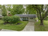 Ranch home with a paved driveway and mature landscaping at 451 Emerson Rd, Carmel, IN 46032