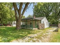 Quaint house with green porch and mature landscaping at 3649 N Sadlier Dr, Indianapolis, IN 46226
