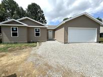 Newly built home with a two-car garage and gravel driveway at 207 N Birchwood Dr, Muncie, IN 47304