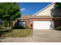 Brick ranch house with a white garage door and landscaping at 5213 Dunewood Way, Avon, IN 46123