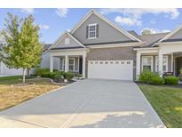 Gray and brick two-story home with white garage door at 17084 Cole Evans Dr, Noblesville, IN 46060
