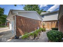 Brick townhouse with attached garage and walkway at 7622 Vintage Ct, Lawrence, IN 46226