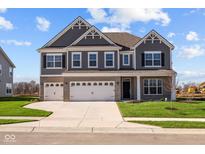 Two-story home with gray siding, white trim, and a three-car garage at 4988 Amber Crest Dr, Brownsburg, IN 46112