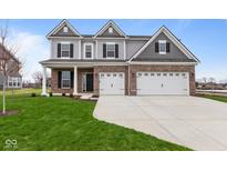 Two-story home with brick and siding, three-car garage, and landscaped lawn at 4959 Amber Crest Dr, Brownsburg, IN 46112