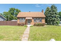 Brick house with brown awning, landscaping, and walkway at 532 E Mills Ave, Indianapolis, IN 46227