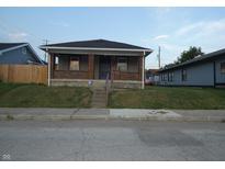 Brick home with front steps and a small yard at 305 Leeds Ave, Indianapolis, IN 46201