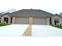 Brick duplex with attached garages and a shared driveway at 980 Paris Dr, Franklin, IN 46131