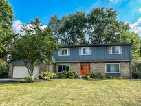 Ranch style home with gray siding, stone accents, and a landscaped yard at 5279 E 75Th St, Indianapolis, IN 46250