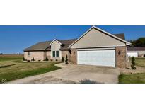 Brick ranch home with attached garage and landscaped yard at 3481 S Budd Rd, Lebanon, IN 46052