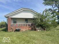 Ranch home with brick facade and a spacious yard at 1452 E Sr 234, Greenfield, IN 46140