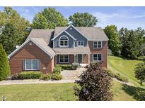 Stunning two-story home with brick and gray siding at 9259 Oak Knoll Ln, Fishers, IN 46037